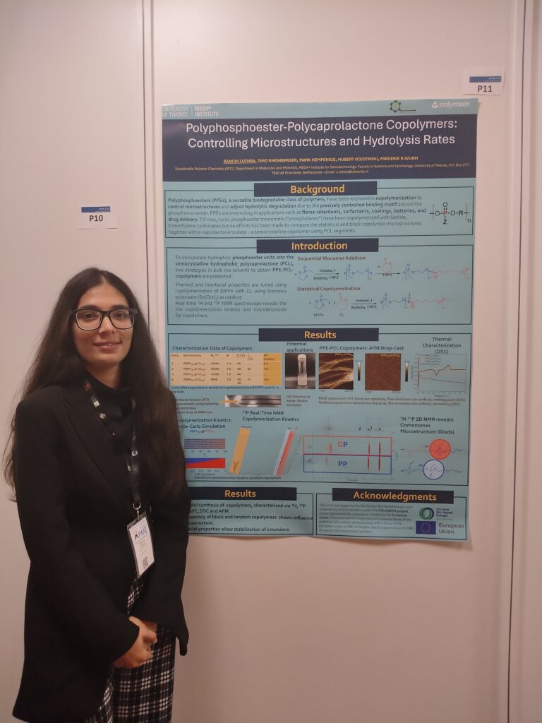 A young woman next to a scientific poster explaining the copolymerisation process.